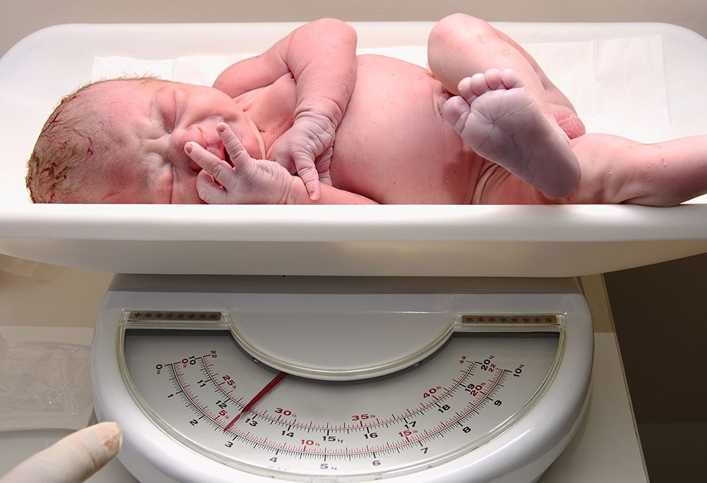 Newborn baby on weighing scale