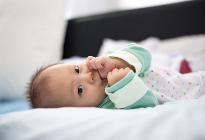 Baby girl sucking her thumb