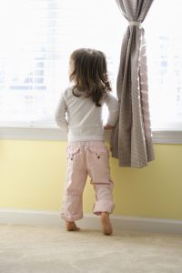 Child standing on tiptoes
