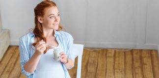 Pregnant woman eating yoghurt
