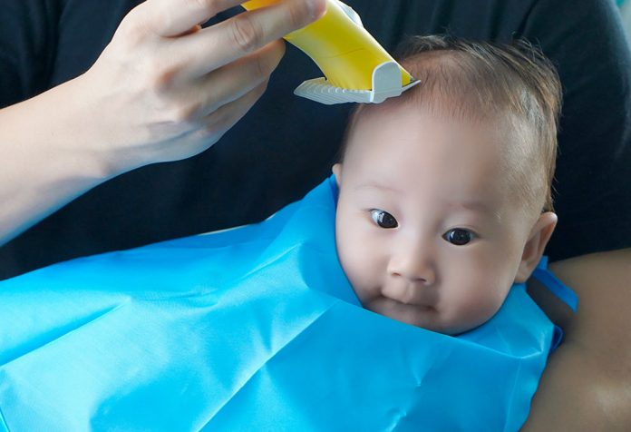A baby getting a haircut