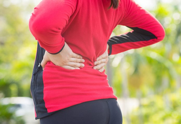A woman suffering from back pain